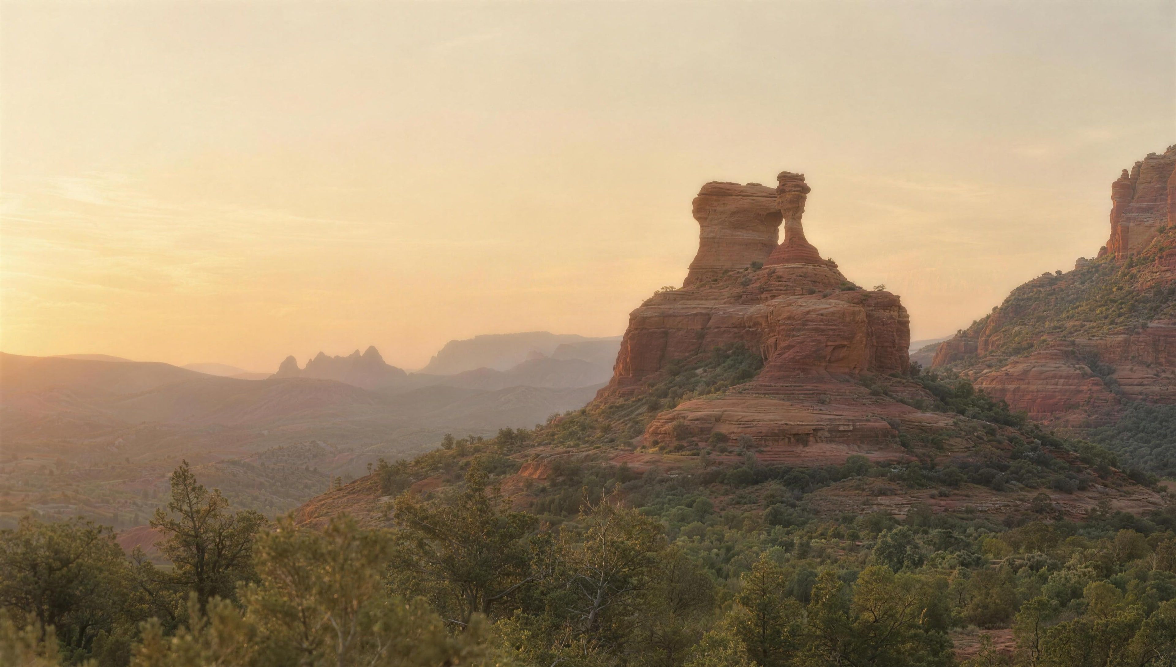 Coffee Pot Rock in Sedona at first light, pale gold sky